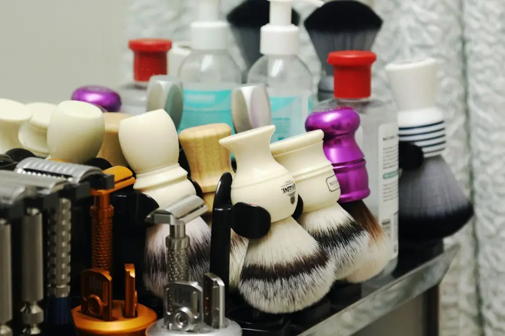 A collection of shaving brushes, razors, and grooming products, illustrating choosing manageable grooming habits